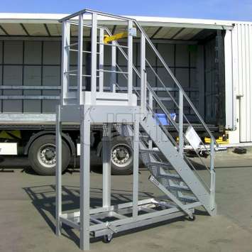 Mobile aluminum workplatform with access stairs, security gate and guardrails.
