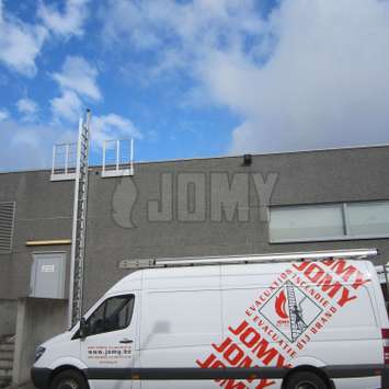 JOMY truck in front of a JOMY Retractable ladder.