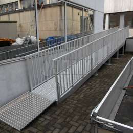 Angled wheelchair ramp in aluminum for building access.