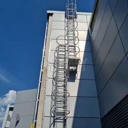 Cage ladders with staggered flights for roof access.