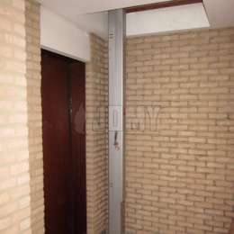 Compact JOMY ladder used in a corridor for accessing a hatch to a machine room above.