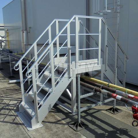 Crossover stairs used over factory piping systems.
