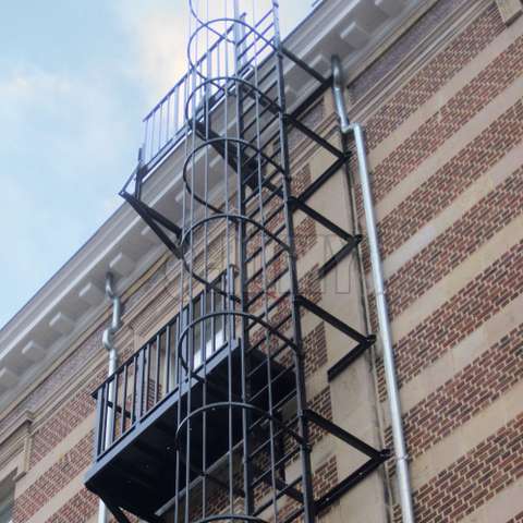 Echelle de secours à crinoline avec palier et balcon d'accès conçus sur mesure.