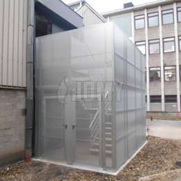 Enclosed staircase in aluminum with perforated panels and security door.