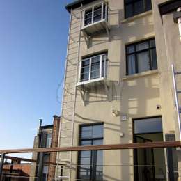 2 story fire escape ladder and balconies for city apartments on two levels.