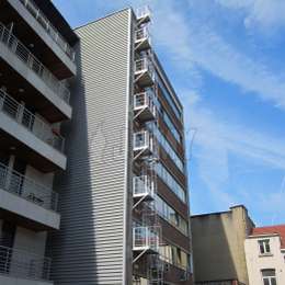 Window fire escape cage ladder with multiple access balconies on the facade of a 7 story office building.