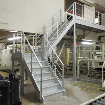 Aluminium stairs inside a factory.