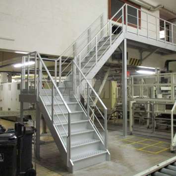 Aluminum stairs inside a factory.