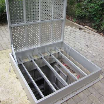 Industrial ground hatch with fall protection.