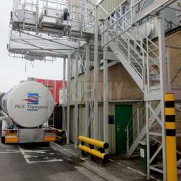 Aluminium construction combining access stairs, pivoting gates, platforms and drop-down ladders, used for accessing tanker truck tops and trailers.