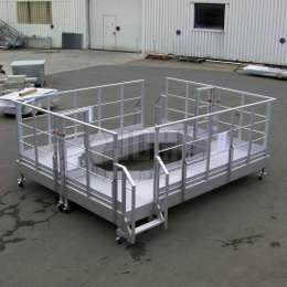 Mobile interlocking industrial platforms on wheels for machine assembly and maintenance.
