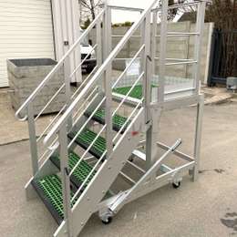 Mobile work platform stairs and platform with polyester steps and floor.
