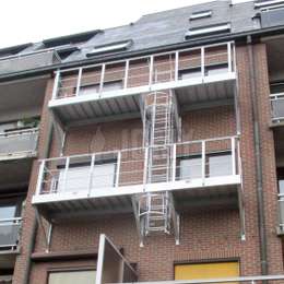 Pass-through access platforms for a fire escape drop-down on an apartment building.