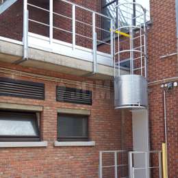 Roof ladder with cage, security door, gate and guardrails used for maintenance.