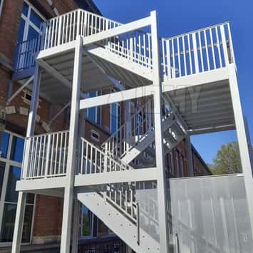 Stair guardrail with vertical tubes.