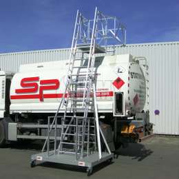 Mobile truck access system for working safely on top of any truck load or tank trailer. Mobile and height adjustable.